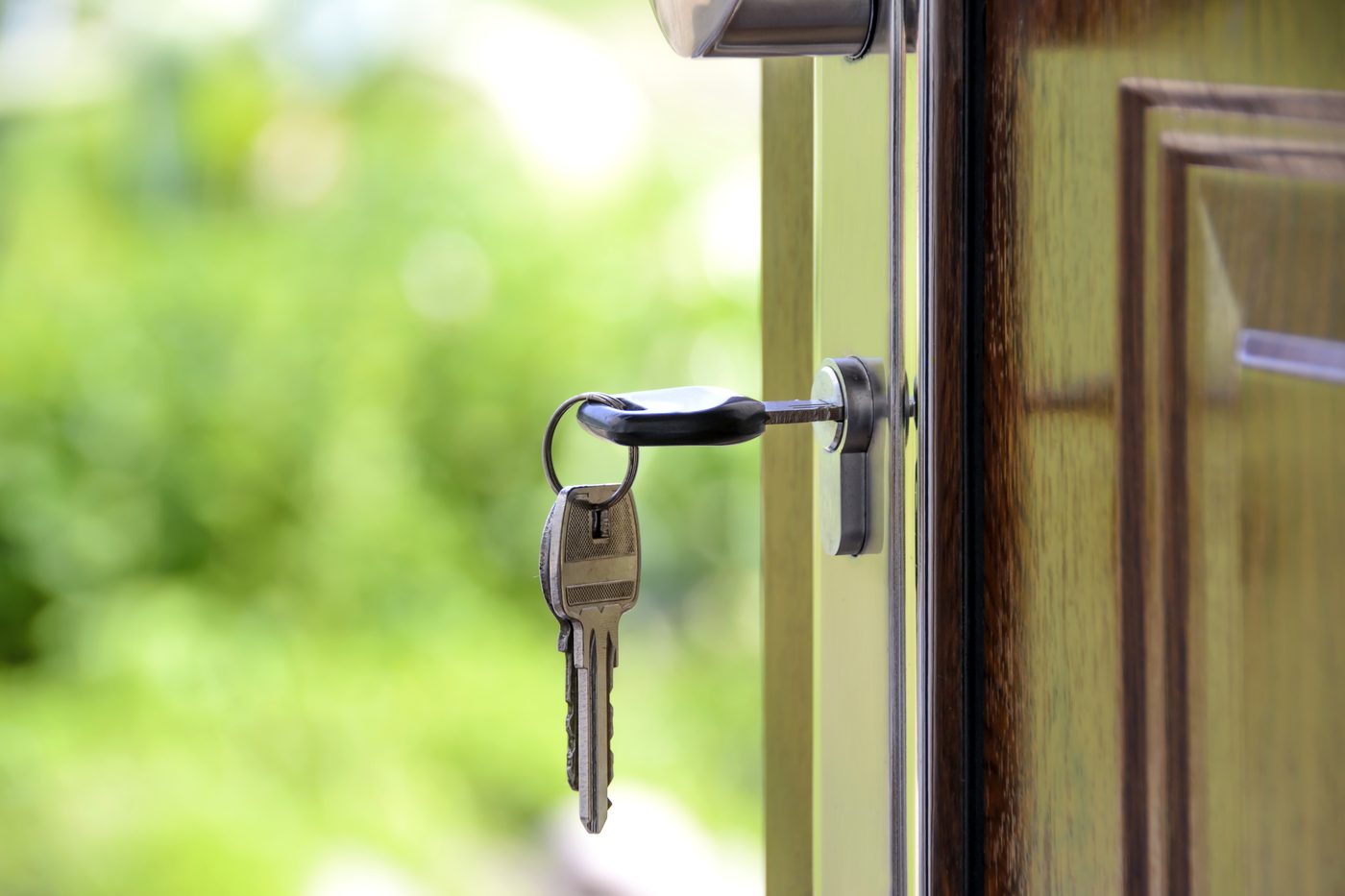 Keys hanging from the lock of an open front door